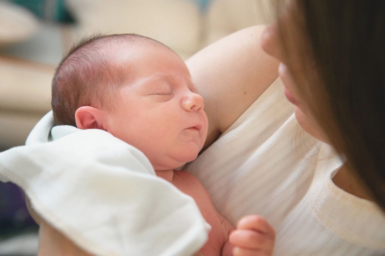 Parent and baby face to face, eye contact, calm moment