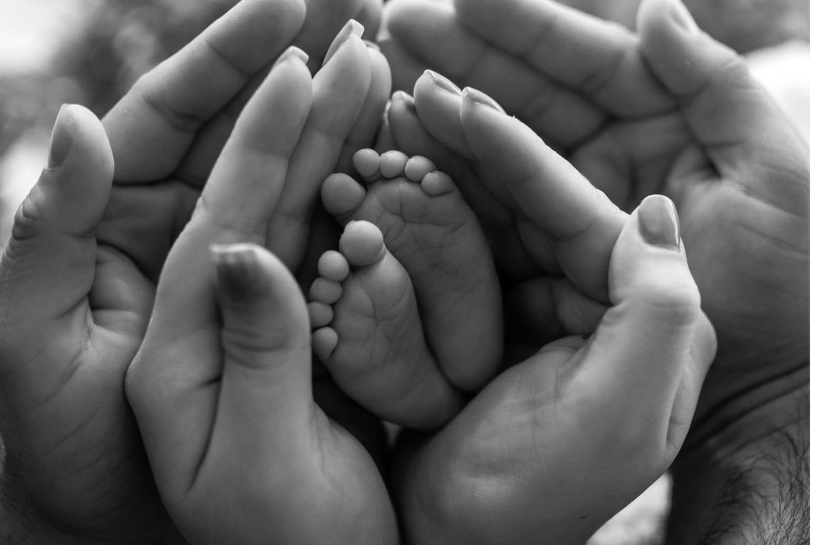 Baby reaching up toward parent, connection moment, warm