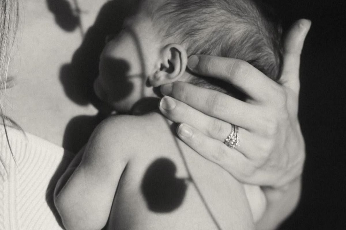 Mother holding newborn in black and white